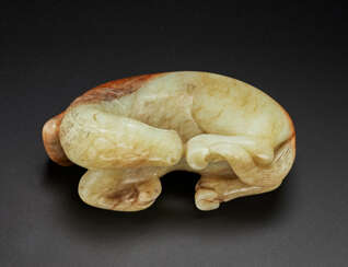 A PALE BEIGE AND RUSSET JADE FIGURE OF A RECUMBENT HORSE