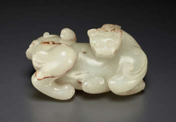 A RARE AND FINELY CARVED WHITE JADE FIGURE OF A MYTHICAL BEAST