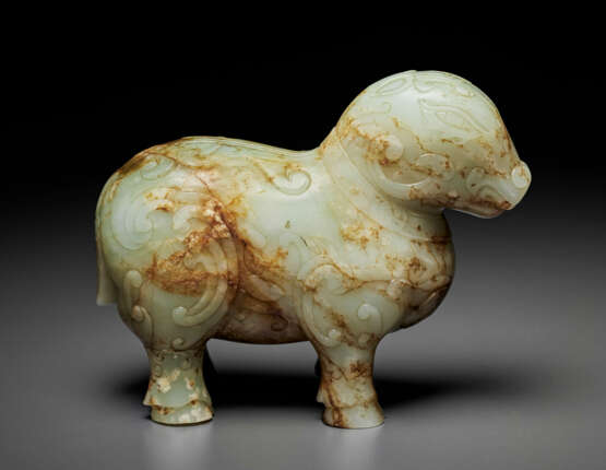 A PALE CELADON AND RUSSET JADE FIGURE OF A MYTHICAL BEAST - photo 1