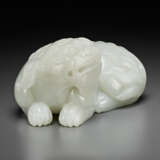 A FINELY CARVED PALE GREYISH-WHITE JADE FIGURE OF A RECUMBENT MYTHICAL BEAST - фото 3