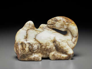 A MOTTLED GREY, BLACK AND RUSSET JADE FIGURE OF A RECUMBENT CAMEL