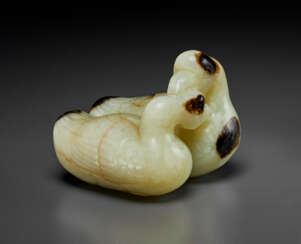 A PALE CELADON AND BLACKISH-BROWN JADE CARVING OF TWO RECUMBENT GEESE