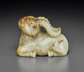 A PALE GREY AND RUSSET-STREAKED JADE CARVING OF A RAM