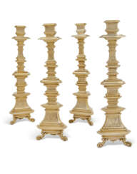 A SET OF FOUR GERMAN SILVER-GILT ALTAR CANDLESTICKS