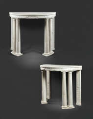 A PAIR OF EMPIRE WHITE MARBLE DEMI-LUNE CONSOLE TABLES