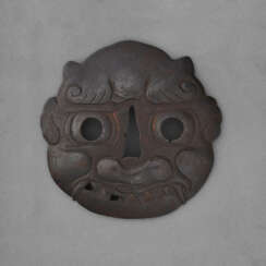 A LARGE IRON TSUBA IN THE FORM OF AN ONI MASK