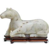 A GREYISH-WHITE JADE FIGURE OF A RECUMBENT HORSE - photo 1