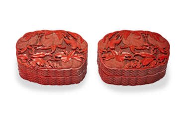 A PAIR OF CARVED RED LACQUER BOXES AND COVERS