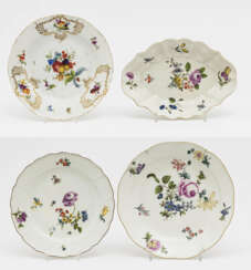 An oval bowl and three plates