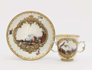 A twin-handled cup with saucer