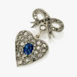 A bow pendant with a heart-shaped pendant - фото 1