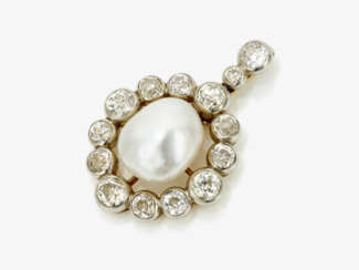 A pendant with a large cultured pearl and diamonds