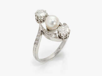 A ring with old brilliant cut diamonds and a cultured pearl