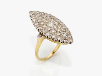 A Marquise ring decorated with brilliant cut diamonds