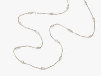 A delicate long link necklace decorated with brilliant cut diamonds