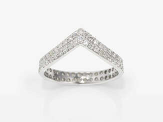 A modified band ring decorated with brilliant cut diamonds