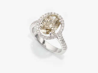 A classic modern cocktail ring decorated with an oval diamond and brilliant cut diamonds