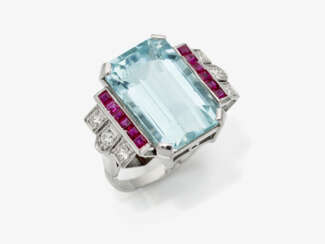 A historical cocktail ring decorated with an aquamarine, rubies and brilliant cut diamonds