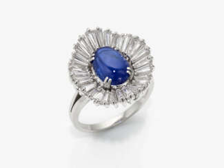 An elegant cocktail ring decorated with a natural cornflower blue sapphire and diamonds