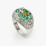 An unique floral cocktail ring decorated with emeralds, a yellow brilliant cut diamond and white brilliant cut diamonds - фото 1