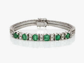 A historical link cocktail bracelet decorated with emeralds and brilliant cut diamonds