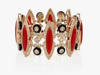 A bracelet with brilliant cut diamonds, corals and onyxes