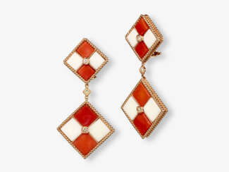 A pair of drop earrings with red and ivory-coloured corals