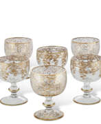 Wine glasses. AN ASSEMBLED SET OF CONTINENTAL GILT-DECORATED GLASS GOBLETS