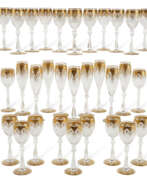 Wine glasses. A BACCARAT GILT CUT-GLASS PART STEMWARE SERVICE