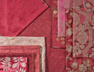 A GROUP OF TEN RED AND RASPBERRY SILK AND SILK METALLIC DAMASKS