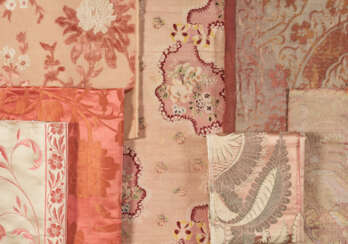 A GROUP OF SEVEN ORANGE AND PINK TEXTILES