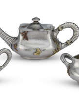 AN AMERICAN SILVER AND MIXED METAL THREE-PIECE 'BACHELOR' TEA SERVICE