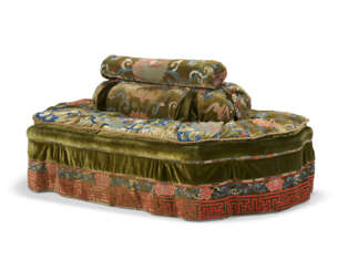 AN OVAL CONFIDANTE UPHOLSTERED IN A CHINESE GREEN-GROUND CUT-VELVET