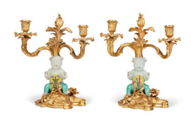 A PAIR OF LOUIS XV ORMOLU AND CHINESE FAMILLE VERTE PORCELAIN TWO-LIGHT CANDELABRA