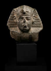 AN EGYPTIAN GRANITE PORTRAIT HEAD OF A PHARAOH