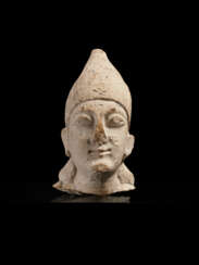 A CYPRIOT LIMESTONE HEAD OF A MALE VOTARY