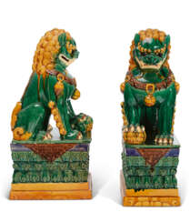 A MASSIVE PAIR OF CHINESE CERAMIC BUDDHIST LIONS ON STANDS