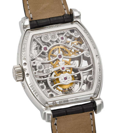 VACHERON CONSTANTIN. A RARE AND HIGHLY ATTRACTIVE PLATINUM TONNEAU-SHAPED SKELETONIZED TOURBILLON WRISTWATCH WITH POWER RESERVE, DATE, CERTIFICATE OF ORIGIN AND BOX - photo 3