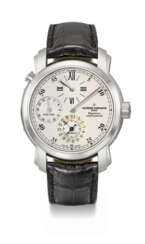 VACHERON CONSTANTIN. AN 18K WHITE GOLD AUTOMATIC DUAL TIME WRISTWATCH WITH DATE, REGULATOR-STYLE DIAL, GUARANTEE AND BOX
