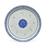A SHALLOW IZNIK BLUE AND WHITE AND SLIP-PAINTED DISH - photo 1