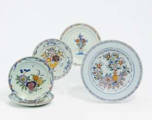 One large and four smaller plates with floral decor