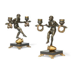 A PAIR OF FRENCH PATINATED AND GILT-BRONZE FIGURAL TWO-LIGHT CANDELABRA