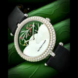VAN CLEEF AND ARPELS. A LADY’S UNIQUE AND ELEGANT 18K WHITE GOLD AND DIAMOND-SET WRISTWATCH WITH DATE AND MONTH INDICATOR, ENAMEL WITH FAIRY MOTIFS AND MOTHER-OF-PEARL DIAL - фото 1