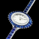 PATEK PHILIPPE. A LADY’S POSSIBLY UNIQUE AND ELEGANT 18K WHITE GOLD, DIAMOND AND SAPPHIRE-SET BRACELET WATCH - photo 2