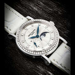 PATEK PHILIPPE. A LADY’S 18K WHITE GOLD AND DIAMOND-SET WRISTWATCH WITH MOON PHASES