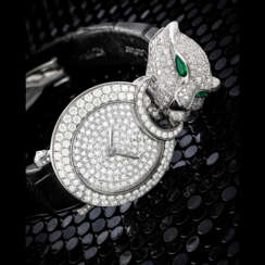 CARTIER. A LADY’S ATTRACTIVE 18K WHITE GOLD, DIAMOND, EMERALD AND ONYX-SET WRISTWATCH