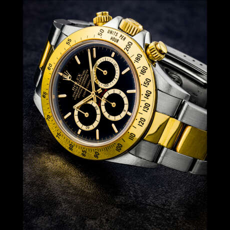 ROLEX. A RARE STAINLESS STEEL AND 18K GOLD AUTOMATIC CHRONOGRAPH WRISTWATCH WITH BRACELET AND “FLOATING” DIAL - photo 1