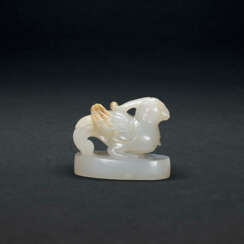 A CARVED WHITE JADE ‘MYTHICAL BIRD’ FINIAL