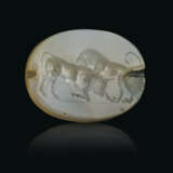 A GRECO-PERSIAN BLUE CHALCEDONY SCARABOID WITH A LION ATTACKING A BULL - photo 1