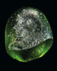 A FRAGMENTARY GREEK GREEN GLASS RINGSTONE WITH A GODDESS